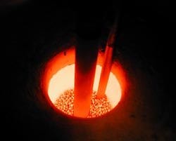 Hot metal is poured into a crucible